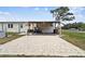 Enjoy the outdoor living space with patio, wooden pergola, and lush green yard at 18906 Merrich Rd, Orlando, FL 32820