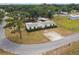 Charming home featuring a well-maintained lawn, trimmed hedges, and eye-catching red shutters at 18906 Merrich Rd, Orlando, FL 32820