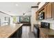 Charming kitchen with dark cabinets, spacious countertops, and an open view to the living room at 18906 Merrich Rd, Orlando, FL 32820