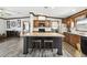 Open kitchen with a center island with bar stool seating and dark wood cabinets at 18906 Merrich Rd, Orlando, FL 32820
