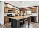 Charming kitchen with wooden cabinets, sleek black appliances, and a center island at 18906 Merrich Rd, Orlando, FL 32820