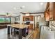 Bright open concept kitchen featuring an island with seating, wood cabinets, and stainless appliances at 18906 Merrich Rd, Orlando, FL 32820