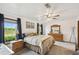 Serene main bedroom with a lake view, complemented by natural wood furniture, for a peaceful retreat at 18906 Merrich Rd, Orlando, FL 32820