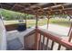 Spacious covered patio with a wooden pergola, brick pavers, and outdoor seating at 18906 Merrich Rd, Orlando, FL 32820