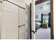 Compact shower area with glass doors and a view into the neutral toned bedroom at 18906 Merrich Rd, Orlando, FL 32820