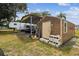 A backyard storage shed offers ample space for tools and equipment, plus a carport at 18906 Merrich Rd, Orlando, FL 32820