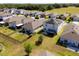 Aerial view of a residential area with homes that have fenced yards and some with solar panels at 2294 Canyon Breeze Ave Ave, Kissimmee, FL 34746