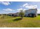 Spacious backyard with well-maintained lawn, fence, patio with pergola, and views of neighboring homes at 2294 Canyon Breeze Ave Ave, Kissimmee, FL 34746