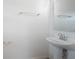 Clean half bathroom with a pedestal sink, a mirror, and a towel rack at 2294 Canyon Breeze Ave Ave, Kissimmee, FL 34746