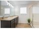 Well-lit bathroom featuring double sinks, vanity, and glass enclosed shower at 2294 Canyon Breeze Ave Ave, Kissimmee, FL 34746
