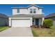 Charming two-story home featuring a two-car garage and a beautifully landscaped front yard at 2294 Canyon Breeze Ave Ave, Kissimmee, FL 34746