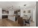 Stylish kitchen featuring granite countertops, dark cabinets, stainless steel appliances, and an island at 2294 Canyon Breeze Ave Ave, Kissimmee, FL 34746
