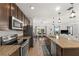 Modern kitchen with stainless steel appliances, granite countertops, and a breakfast bar at 2294 Canyon Breeze Ave Ave, Kissimmee, FL 34746