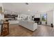 Spacious living room featuring an open floor plan, wood-look flooring, and abundant natural light at 2294 Canyon Breeze Ave Ave, Kissimmee, FL 34746