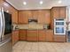 Modern kitchen with stainless appliances, granite countertops, and ample cabinet space at 2365 Sterling Creek Pkwy, Oviedo, FL 32766