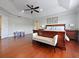 Spacious main bedroom with tray ceiling, hardwood floors, and ensuite bathroom at 2365 Sterling Creek Pkwy, Oviedo, FL 32766