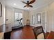 Office boasts wood floors, a treadmill, and a pair of glass doors at 2365 Sterling Creek Pkwy, Oviedo, FL 32766
