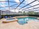 Screened-in pool with spa, tile decking and surrounding shrubs at 2365 Sterling Creek Pkwy, Oviedo, FL 32766