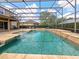 Spacious screened-in pool area, featuring a spa, lounge area, and a covered patio for outdoor dining at 2365 Sterling Creek Pkwy, Oviedo, FL 32766