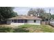 Exterior back of home featuring a screened porch and a fenced-in yard at 2404 Timbercreek E Loop, Lakeland, FL 33805
