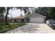 Charming single-story home with well-maintained lawn, long driveway, and attached two-car garage at 2404 Timbercreek E Loop, Lakeland, FL 33805