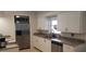 Bright kitchen with modern appliances, granite countertops, and white cabinetry at 2404 Timbercreek E Loop, Lakeland, FL 33805