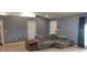 Spacious living area with neutral paint, tile flooring, and comfortable sectional sofa at 2404 Timbercreek E Loop, Lakeland, FL 33805