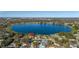 Aerial view shows the home's location on the lake with a panoramic view of the surrounding neighborhood at 241 Lake Thomas Dr, Winter Haven, FL 33880