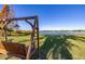 Tranquil backyard scene with a wooden swing set and serene lake views and wooden pier at 241 Lake Thomas Dr, Winter Haven, FL 33880