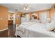 Cozy bedroom with white furniture, wood floors, and natural light creates a relaxing retreat at 241 Lake Thomas Dr, Winter Haven, FL 33880