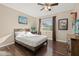 Comfortable bedroom with dark hardwood floors, light tan walls, and bright natural light at 241 Lake Thomas Dr, Winter Haven, FL 33880