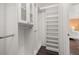 Walk-in closet with custom shelving, hanging rods, and ample storage space at 241 Lake Thomas Dr, Winter Haven, FL 33880