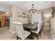 Cozy dining room with elegant chandelier, neutral walls, and views into other living spaces at 241 Lake Thomas Dr, Winter Haven, FL 33880