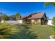Charming single-story home with well-maintained lawn, lush landscaping, and attached garage at 241 Lake Thomas Dr, Winter Haven, FL 33880