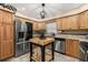 Well-appointed kitchen with stainless steel appliances, custom cabinetry, and a stylish center island at 241 Lake Thomas Dr, Winter Haven, FL 33880