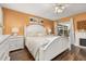 Inviting main bedroom with white furniture set, wooden floors, and a sliding glass door at 241 Lake Thomas Dr, Winter Haven, FL 33880