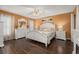 This bedroom features a ceiling fan, white furniture and wood-look flooring at 241 Lake Thomas Dr, Winter Haven, FL 33880