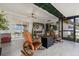 Inviting screened patio with rocking chairs, swing, and garden decor for outdoor relaxation at 241 Lake Thomas Dr, Winter Haven, FL 33880