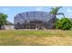 Large screened-in patio and swimming pool overlooking the green backyard at 2787 Cypress Head Trl, Oviedo, FL 32765