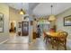 Inviting foyer with tile flooring, a decorative front door, and views into the dining area at 2787 Cypress Head Trl, Oviedo, FL 32765