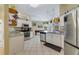 Open kitchen with stainless steel appliances and granite countertops, adjacent to a game room at 2787 Cypress Head Trl, Oviedo, FL 32765