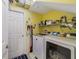 Laundry room featuring a side-by-side washer and dryer, shelves, and decor at 2787 Cypress Head Trl, Oviedo, FL 32765