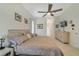 Relaxing main bedroom with tile floors, a ceiling fan, and ensuite bathroom access at 2787 Cypress Head Trl, Oviedo, FL 32765