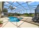Inviting screened-in pool and patio area with a spa overlooking the tranquil lake at 2787 Cypress Head Trl, Oviedo, FL 32765