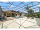 Expansive screened-in pool area with a spillover spa, stone bar, and plenty of room for outdoor seating at 2787 Cypress Head Trl, Oviedo, FL 32765