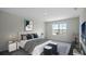 Comfortable main bedroom with a queen-size bed, stylish decor, and a large window providing ample natural light at 2919 Moulin Rd, Davenport, FL 33837