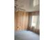 Bedroom featuring wood-paneled walls, carpeted floors, ceiling fan, and natural light at 3009 Manatee Rd, Tavares, FL 32778