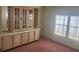 Dining room featuring a built-in hutch and two large windows, carpeted floor, ample natural light at 3009 Manatee Rd, Tavares, FL 32778