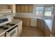 Kitchen featuring light tan cabinets, white countertops, and modern appliances at 3009 Manatee Rd, Tavares, FL 32778