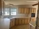 Traditional kitchen featuring tan cabinetry, laminate countertops and a stainless steel sink at 3009 Manatee Rd, Tavares, FL 32778